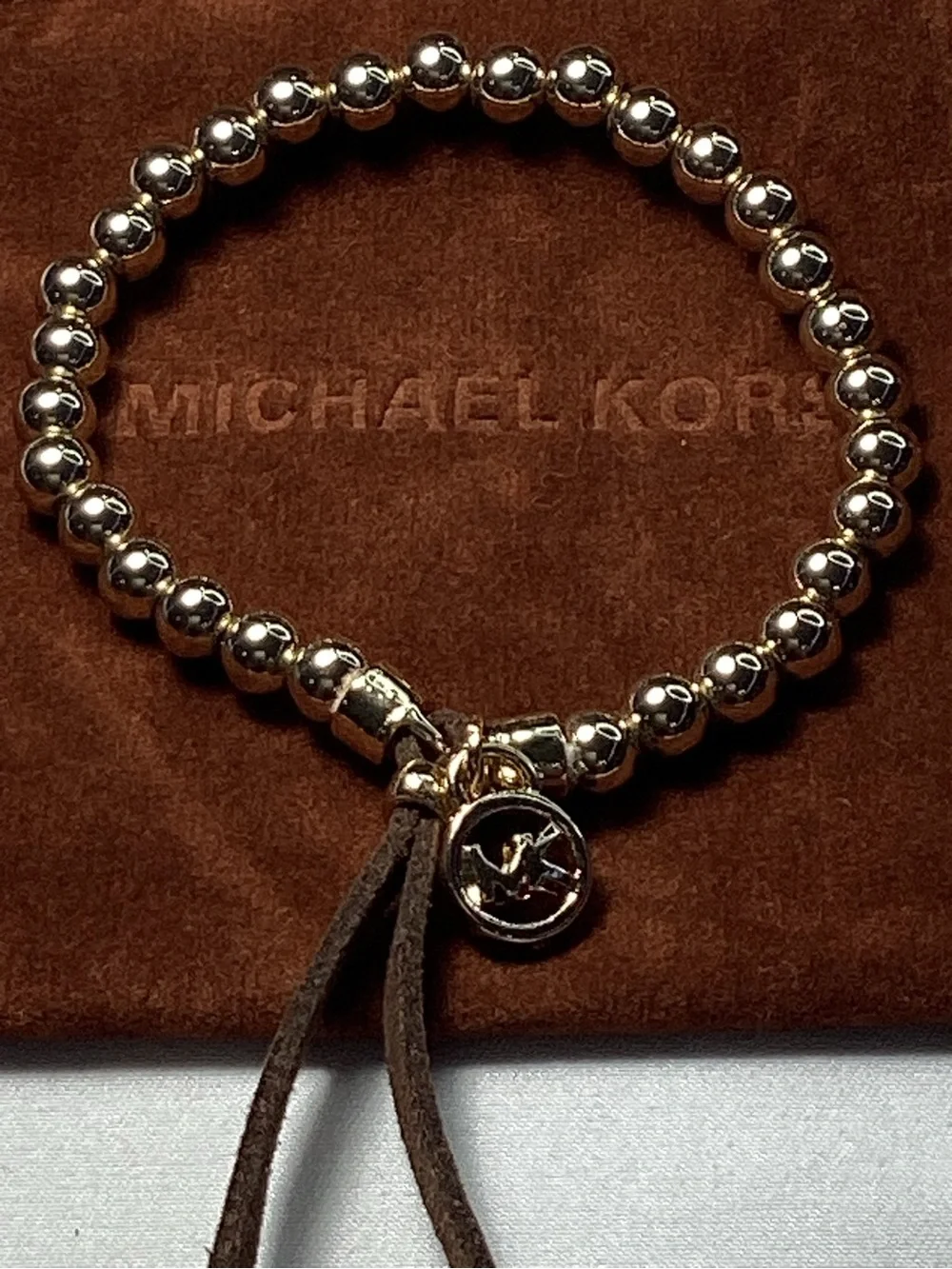 Michael Kors NWT and Dust Bag Gold-Tone Beaded Brown Suede Logo Charm Bracelet